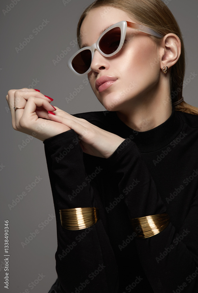 Beautiful young woman in sunglasses. blond girl in glasses and bracelets