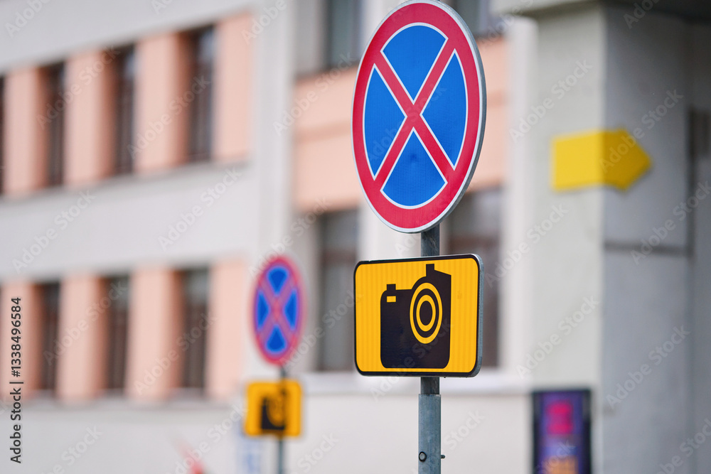 No parking sign with surveillance camera symbol, warning drivers about restricted areas, traffic rules, and potential fines for violations in public spaces.