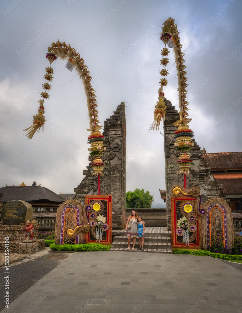 The stunning Balinese Ulun Danu Beratan Temple gate, which is intricately decorated, stands proudly against a picturesque sky, making it must see landmark for all travelers, Bali, Indonesia