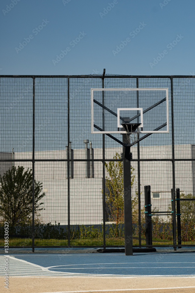 Outdoor public basketball hoop at sport stadium . Vertical format.