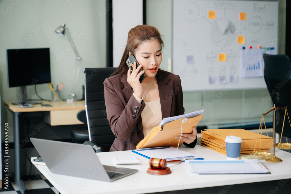 Confident lawyer working on legal analysis at a modern office desk, featuring scales of justice, a gavel Confident lawyer working on legal analysis at a modern office desk, featuring scales of justice, a gavel