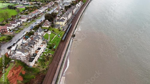 Following a train along Dawlish seafront railway line photo