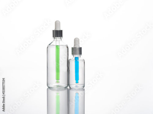 transparent dropper bottle with white bottom and colored dropper