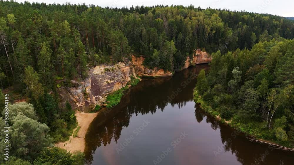 Spectacular Birds Eye Reveal Over The Ancient Sandstone Cliffs (Erglu Klintis) And Devonian Rock Formations Along The Famous Gauja River Valley In Gauja National Park, Latvia. Spectacular Birds Eye Reveal Over The Ancient Sandstone Cliffs (Erglu Klintis) And Devonian Rock Formations Along The Famous Gauja River Valley In Gauja National Park, Latvia.