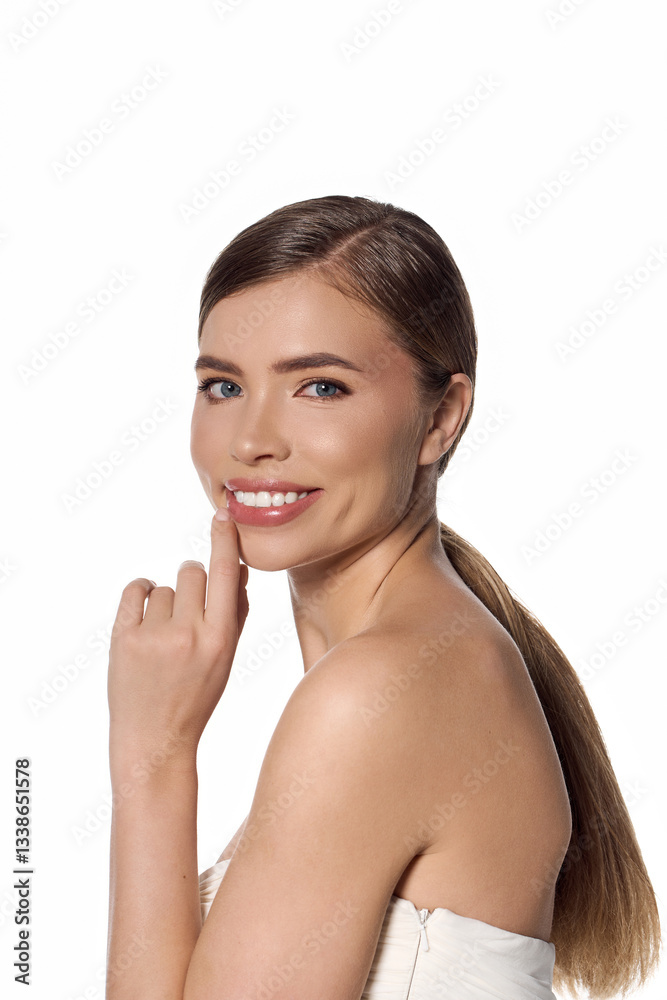 Elegant young woman smiling gracefully while showcasing her stylish demeanor in a bright setting Elegant young woman smiling gracefully while showcasing her stylish demeanor in a bright setting