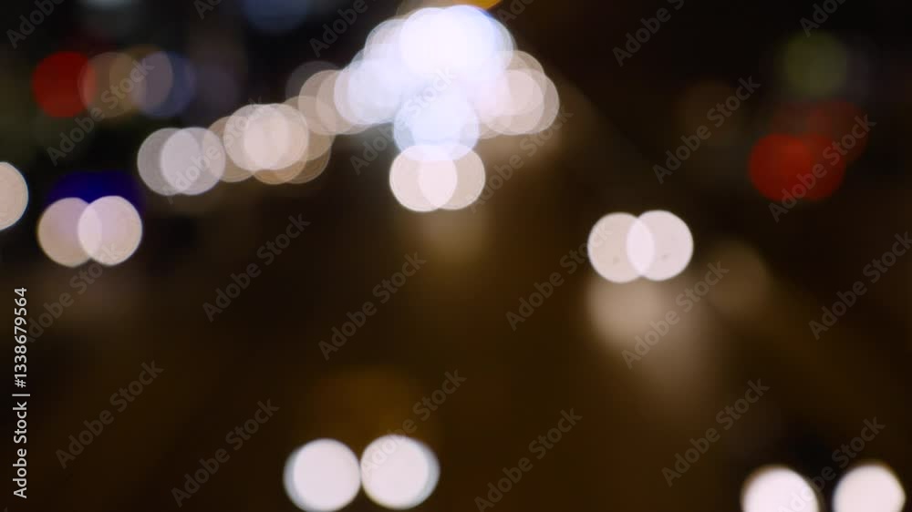 Blurred bokeh traffic on the road at night in a big city.