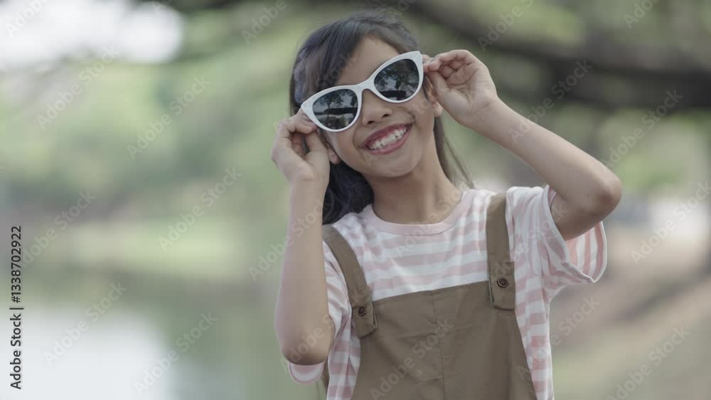 A little girl is wearing sunglasses to protect her eyes.