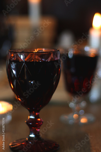 Obraz na płótnie Books, lit candles, red wine, snacks and various deocration on the table. Dark academia or Halloween concept. Selective focus. w salonie
