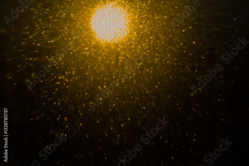 Blurred bokeh light sparkle on golden black background