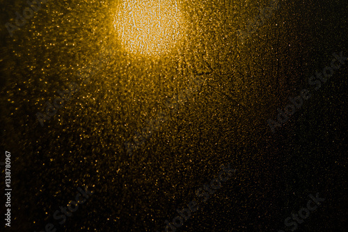 Blurred bokeh light sparkle on golden black background