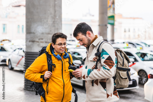 Billede på lærred Tourists using rideshare app, requesting transportation service near taxi rank