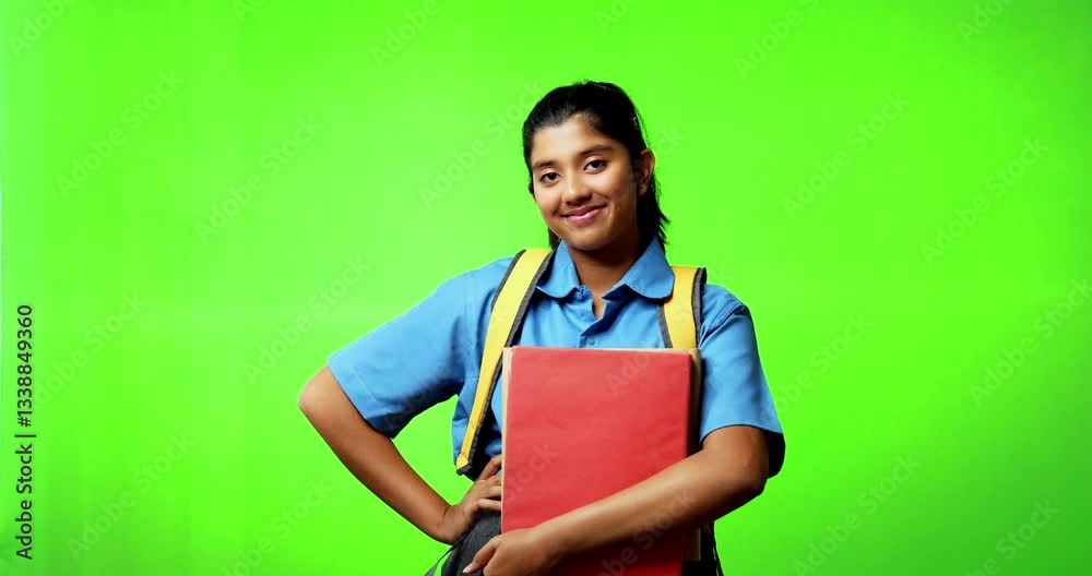 Indian Asian teenage girl in school uniform standing against green chroma screen, happily holding books, looking at camera with a cheerful smile, symbolizing education, learning, success, student life Indian Asian teenage girl in school uniform standing against green chroma screen, happily holding books, looking at camera with a cheerful smile, symbolizing education, learning, success, student life