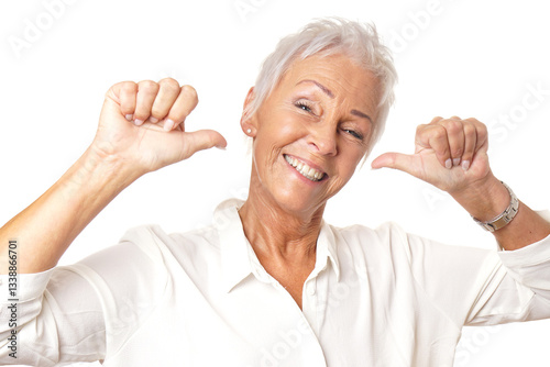 Happy egocentric senior woman pointing both thumbs at herself, expressing self confidence and pride