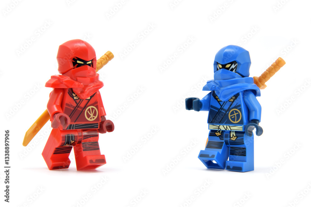 Fototapeta premium Editorial illustrative image of meeting of two lego ninjago minifigures fire ninja Kai and Jay isolated on white.