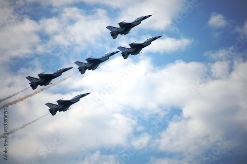 Military aircraft team flying wingover for show thai people foreign travelers and family and child in National Children Day at Don Mueang Royal Thai Air Force on October 10, 2009 in Bangkok, Thailand