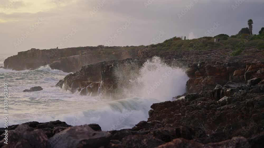 Waves breaking over dangerous rocks. Awesome power of waves breaking over dangerous rocks, breaking up into tiny drops Waves breaking over dangerous rocks. Awesome power of waves breaking over dangerous rocks, breaking up into tiny drops