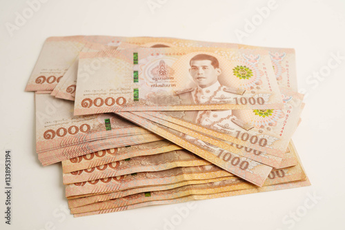Konstfotografi Asian woman counting Thai baht banknote money and holding in hand isolated on white background