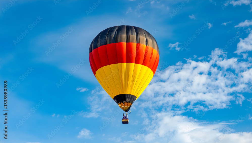 Naklejka premium Colorful hot air balloon soaring against a clear blue sky during a sunny day in Germany
