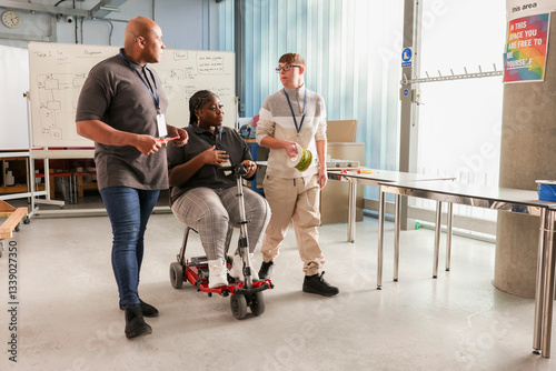 Disabled men and woman talking in workshop photo