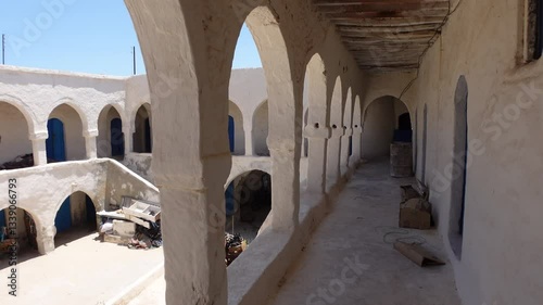 Walking through historic caravanserai in Houmt Souk, classic architecture and landmark building in Tunisia
 photo