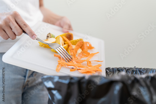Canvastavla Compost from leftover food in the meal in household, female hand holding left over meal use fork scraping waste, rotten vegetable throwing away into garbage, trash or bin