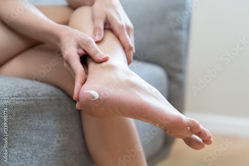 Wallpaper Mural Close-up bare feet of person applying moisturiser cream on foot heel Torontodigital.ca