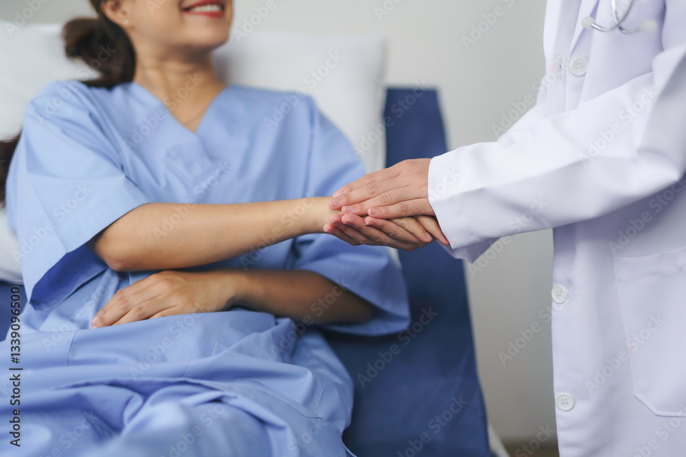 Obraz premium Doctor is holding hand of smiling patient lying in hospital bed, showing empathy and support