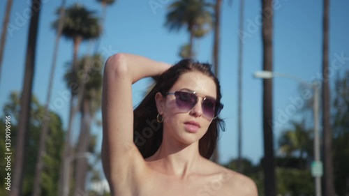 Female fashion model walking down a street in Beverly Hills