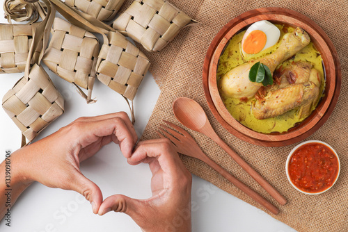 Lontong opor ayam is an Indonesian traditional dish usually served during eid Mubarak, Eid al Fitr holiday celebration with Ketupat Lebaran or rice cake dumpling and sambal chili sauce.