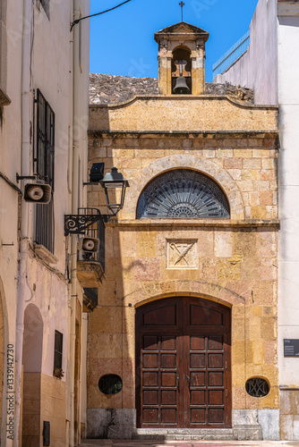 Close view of theentrance of Sant Magi (Saint Maginus) chapel in a small alley in the old town of Tarragona in summer, Tarragona, Catalonia, Spain