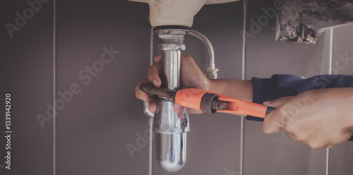 plumber at work in a bathroom, plumbing repair service , fix water plumbing leaks, replace the kitchen sink drain