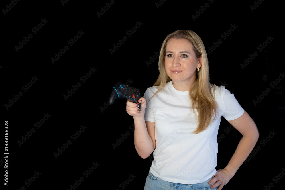 Photo of blonde happy excited crazy smiling woman playing videogames addicted to playstation isolated black background. gamer girl Photo of blonde happy excited crazy smiling woman playing videogames addicted to playstation isolated black background. gamer girl