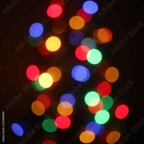 A lively background featuring out-of-focus multicolored string lights, creating a vibrant bokeh effect. The blurred circles of red, yellow, blue, and green lights give a festive and joyful atmosphere.