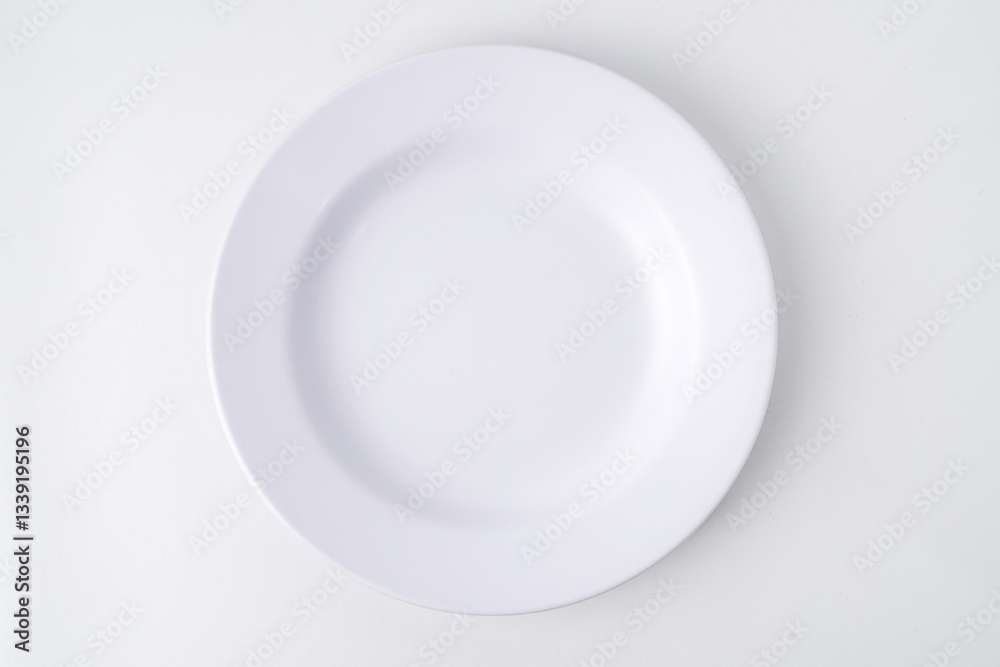 Empty white colored round shaped plate. Isolated on white background. Flat Lay Setup Empty white colored round shaped plate. Isolated on white background. Flat Lay Setup