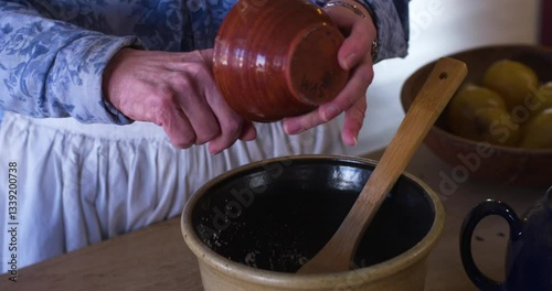women pouring seasoning into bowl