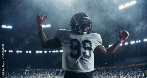 Foto Portrait of Male Football Player Celebrating Scoring a Successful Touchdown Under Heavy Rain