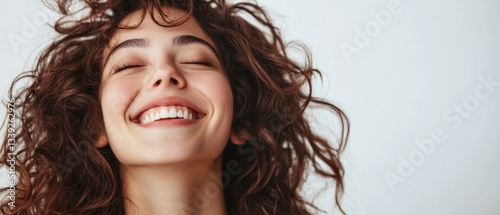 Cute adult smiling positive woman model, joyful pretty cheerful cute curly girl student laughing having fun feeling happy healthy standing isolated at white background, authentic candid studio shot.