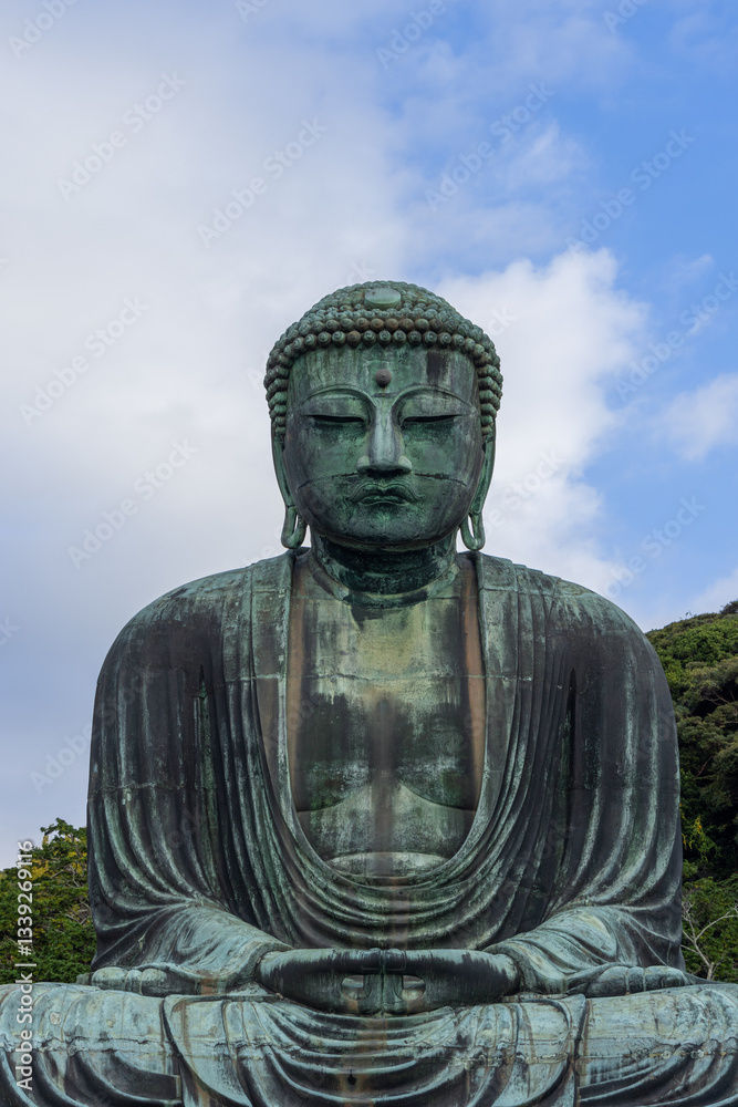Historic bronze Buddha statue at Kotoku-in temple in Kamakura Japan sitting in a meditation posture with intricate details and a weathered surface Historic bronze Buddha statue at Kotoku-in temple in Kamakura Japan sitting in a meditation posture with intricate details and a weathered surface