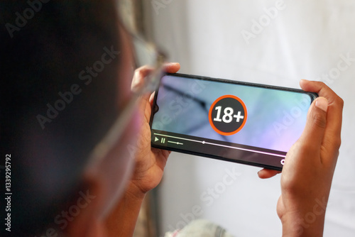 Person Watching 18 Plus Content on Smartphone