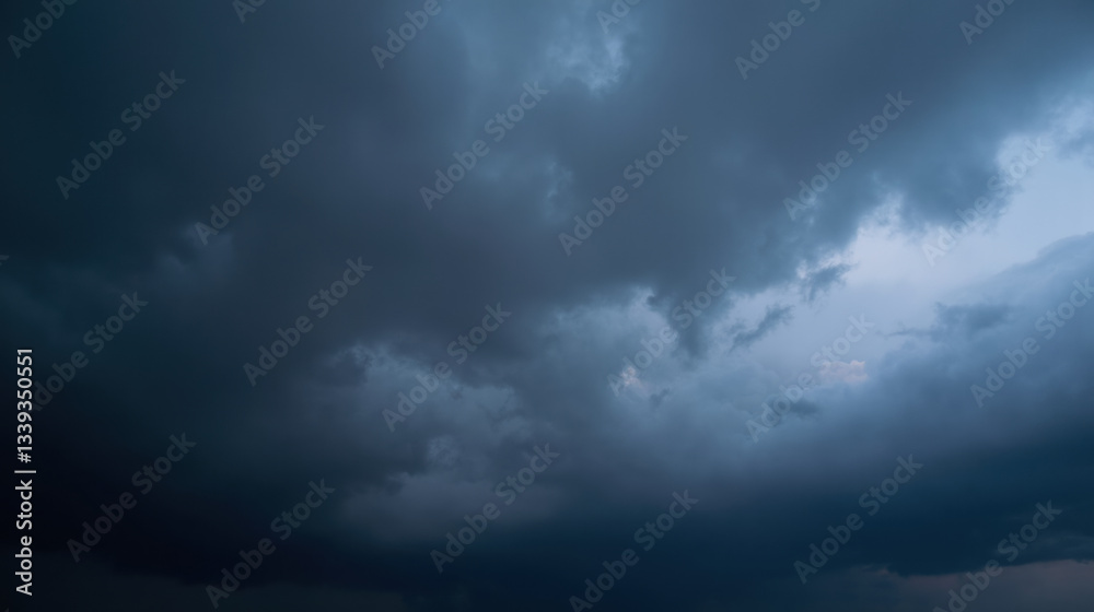 Dramatic dark clouds fill sky, creating moody atmosphere before storm Dramatic dark clouds fill sky, creating moody atmosphere before storm