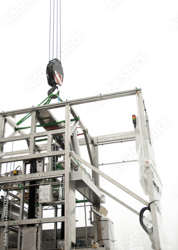 Loading with a crane a new machine for the production of medicines.