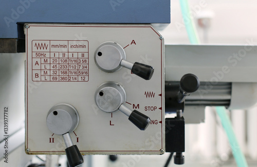 Lathe machine control panel. A close-up of a lathe machine control panel with feed adjustment levers. 