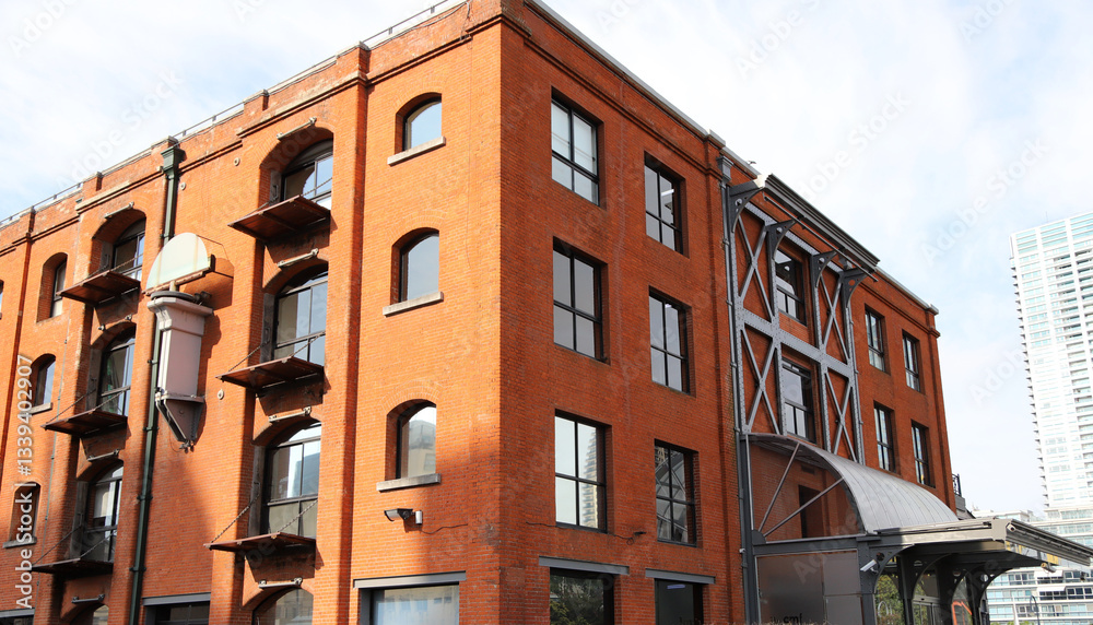 Fototapeta premium Industrial style building facade with red bricks 