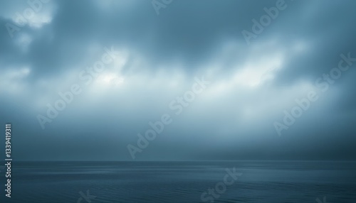 Dramatic Cloudy Sky Over Calm Water Creates Peaceful Coastal Landscape at Dusk
