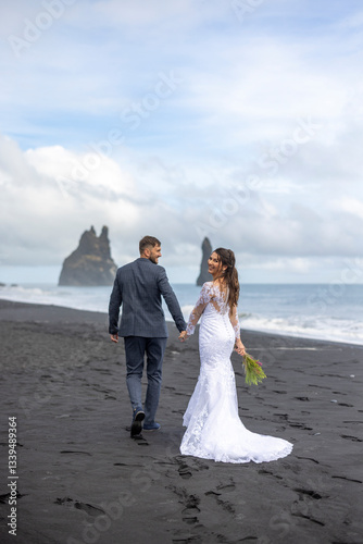This stunning wedding photo at Reynisfjara Black Sand Beach captures true love against Icelands breathtaking landscapes, evoking adventure and romance for couples cherishing unforgettable moments
