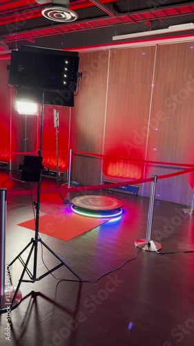  A 360-degree photo booth setup with professional lighting and red carpet, enclosed by stanchions, ready for event photography and videography.