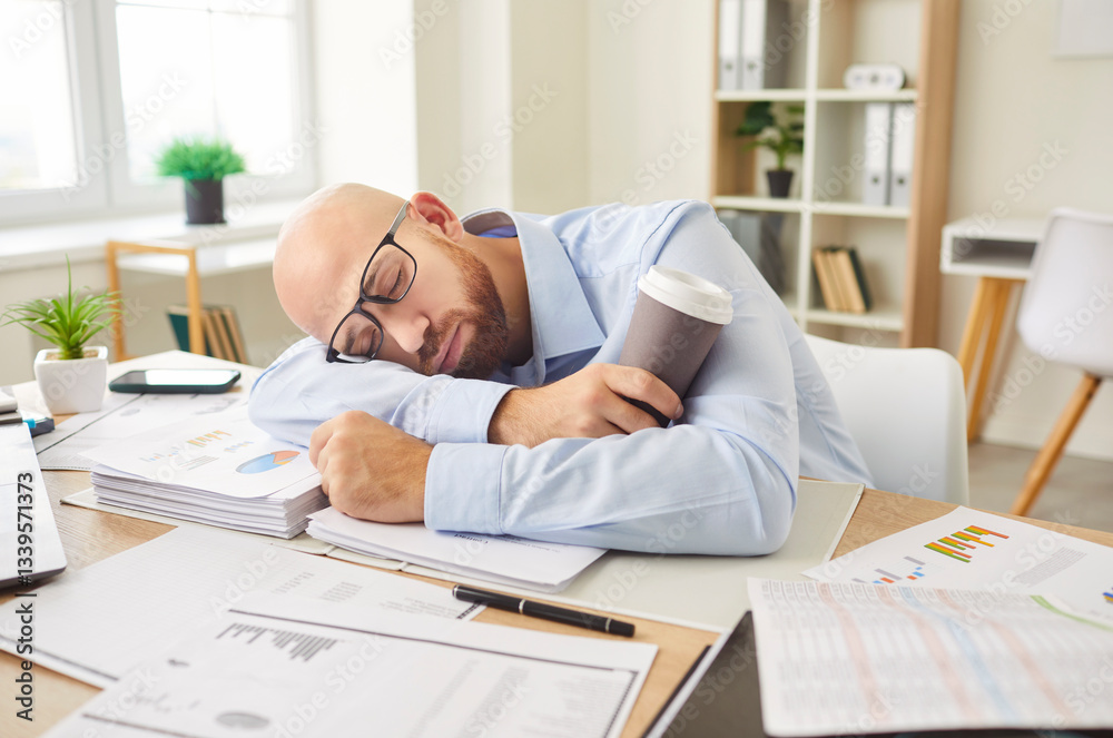 Man sleeping on a table covered with documents in an office, exhausted from work. Coffee cup suggests burnout and stress, highlighting the impact of tiredness in a demanding work environment. Man sleeping on a table covered with documents in an office, exhausted from work. Coffee cup suggests burnout and stress, highlighting the impact of tiredness in a demanding work environment.