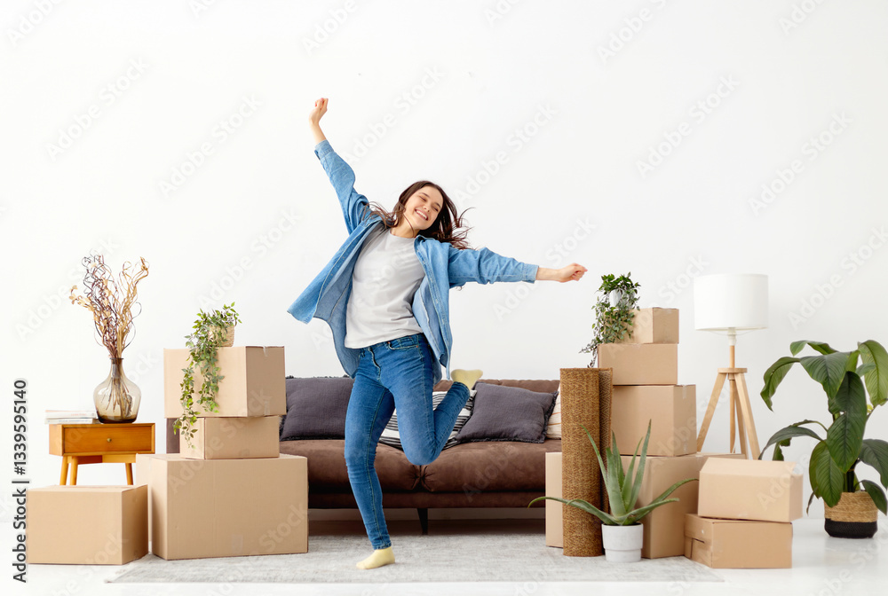 Happy woman jumping among moving boxes at home