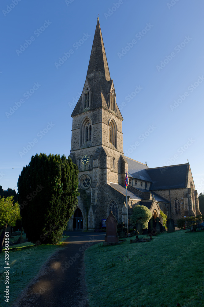 Swindon Christ Church entrance on a sunny morning in the winter. Footpath towards the entrance. Vertical view.