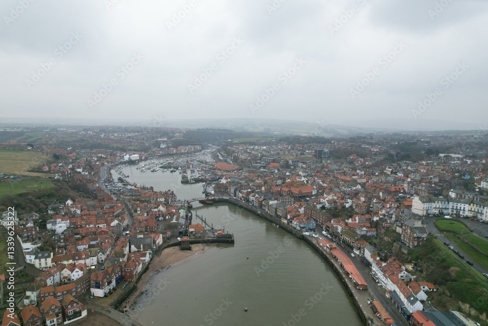 Fototapeta premium Panorama of Whitby harbor town in England with Gothic cathedral on the hill and sea port view, concept of tourism and historic architecture 